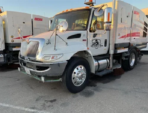 Mechanical sweeper truck service for construction cleanup and track-out control